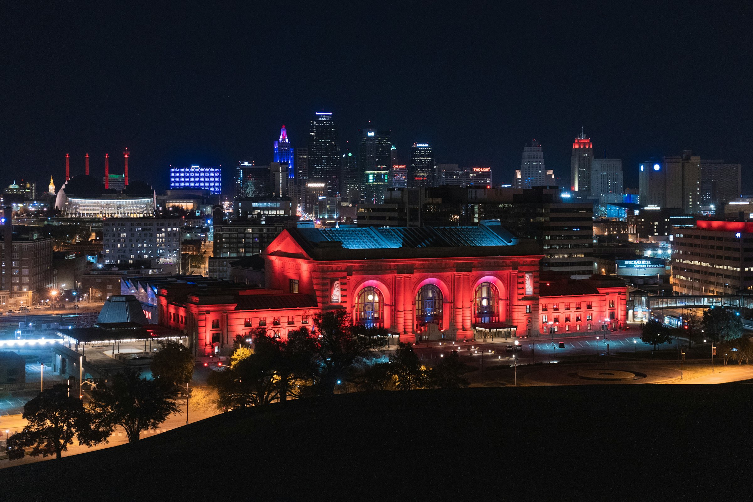 Union Station and the Kansas City skyline lit up in red at night
